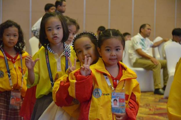 A group of young girls posing for a photo
Description automatically generated