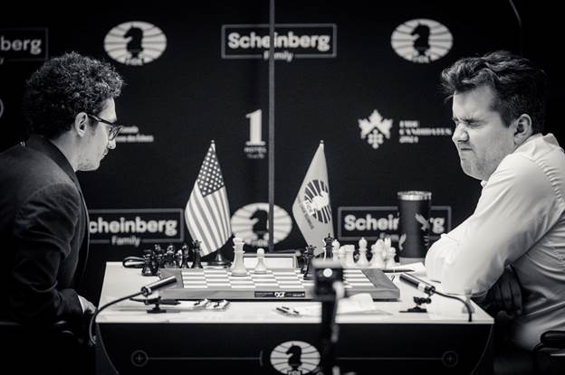 May be an image of 2 people, chess and text